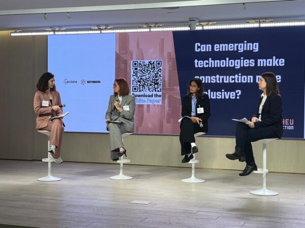 women sitting on stage at an event