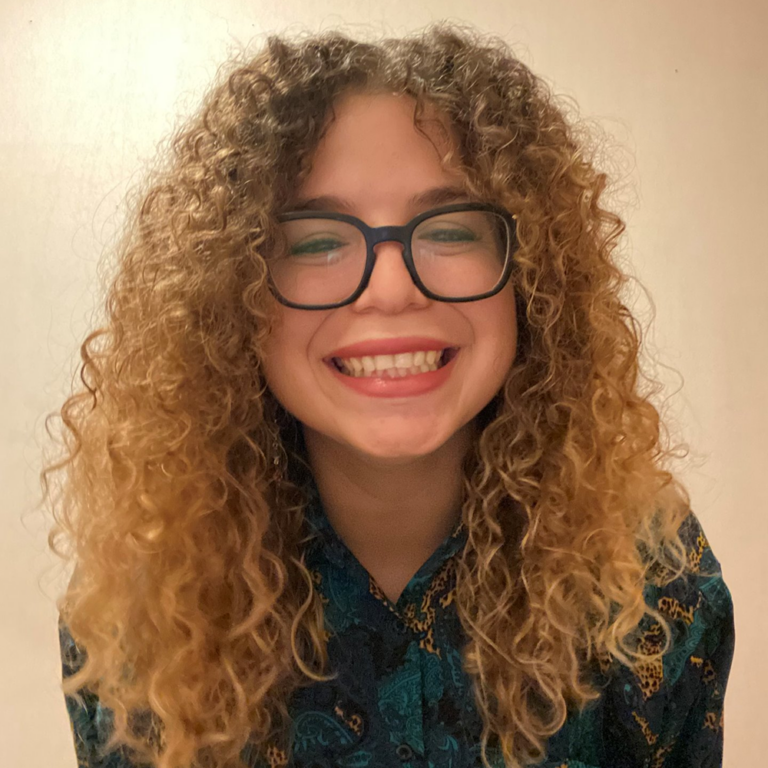 woman with curly hair and glasses